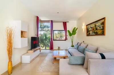 a living room with a couch and a fireplace at Appartement d'Exception-Piscine in Marrakech