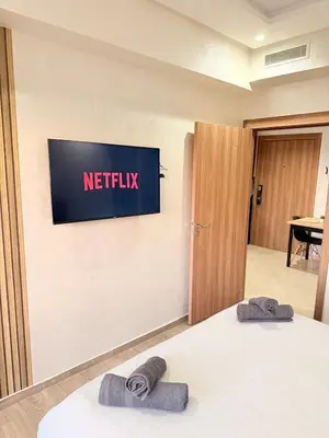 a hotel room with a television on the wall at Appartement au cœur de Marrakech in Marrakech