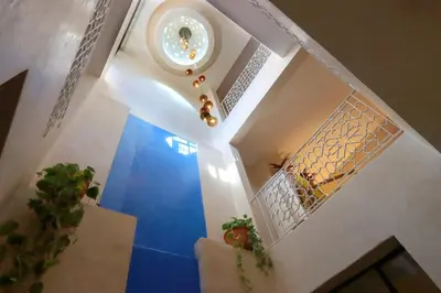 a hallway with a blue floor and some plants at Souffle d 'Orient, easy access to medina & basin in Marrakech