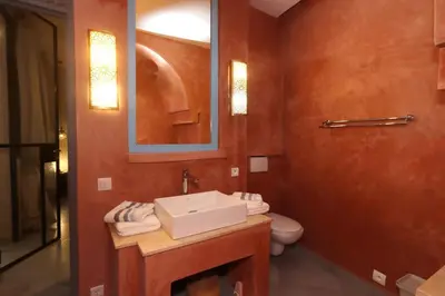 a bathroom with a sink and a toilet at Souffle d 'Orient, easy access to medina & basin in Marrakech