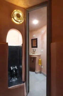 a bathroom with a shower with a sink and a mirror at Souffle d 'Orient, easy access to medina & basin in Marrakech