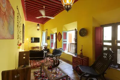 a living room with yellow walls and a red ceiling at Riad Al Kamar, private, 2 min from Jema El Fna Square in Marrakech