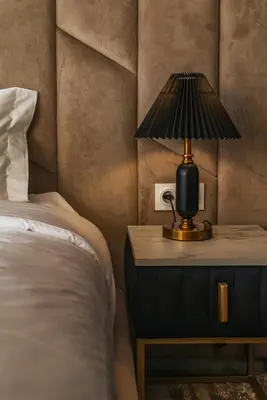 a bedroom with a bed and a lamp on a nightstand at Villa Elysée - Piscine et jardin Privée Sans vis-à-vis Wifi HD in Sraghna