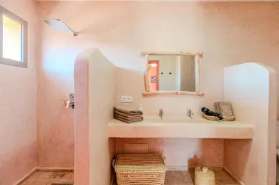a bathroom with a sink and a mirror at Villa d Exception 5 suites et piscine privee in Marrakech
