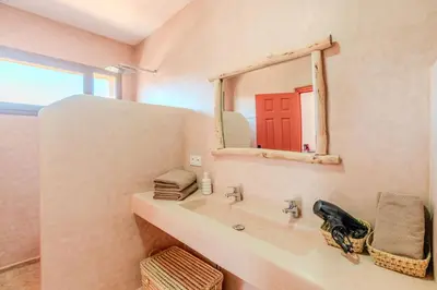 a bathroom with a sink and a mirror at Villa d Exception 5 suites et piscine privee in Marrakech