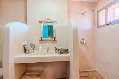 a bathroom with a sink and a mirror at Villa d Exception 5 suites et piscine privee in Marrakech
