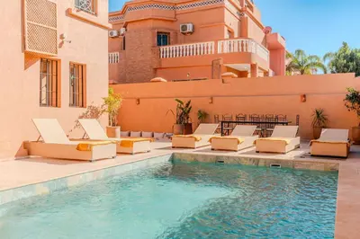 a villa with a swimming pool and lounge chairs at Villa d Exception 5 suites et piscine privee in Marrakech