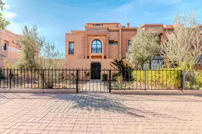 a building with a gate in front of a building at Villa d Exception 5 suites et piscine privee in Marrakech