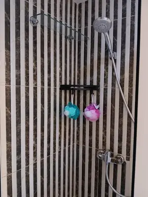 a shower in a bathroom with a shower head at Apartement Gueliz Marrakech in Marrakech