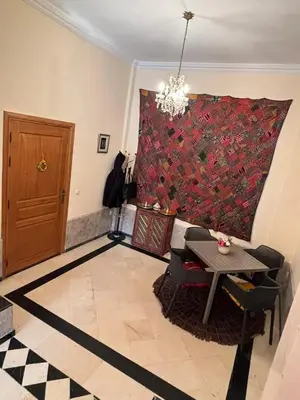 a living room with a large red painting on the wall at Family residence with a pool in Marrakech
