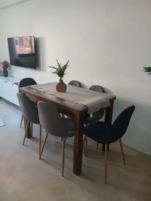 a dining room table with a potted plant on it at marrakech semlalia gueliz in Marrakech