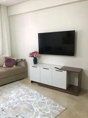 a living room with a flat screen tv on a wall at marrakech semlalia gueliz in Marrakech