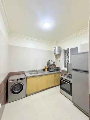 a kitchen with a sink and a stove and a refrigerator at Appartement Calme Parfait & Centre-ville in Marrakech