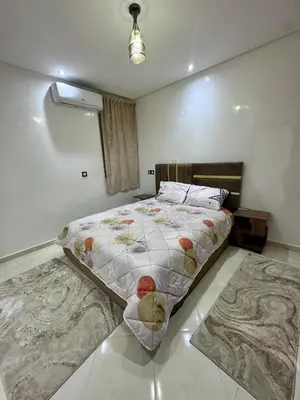 a bedroom with a large bed and two rugs at RENTSUITE SPACIOUS and COMFY 2 BEDROOM in Marrakech
