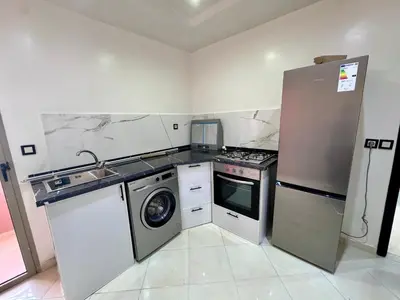 a kitchen with a refrigerator and a washing machine at RENTSUITE SPACIOUS and COMFY 2 BEDROOM in Marrakech