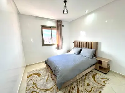 a bedroom with a bed and a rug at RENTSUITE SPACIOUS and COMFY 2 BEDROOM in Marrakech