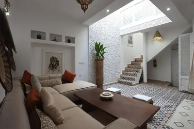 a living room with a couch and a table at Dar Bensuh 2ch privé in Marrakech