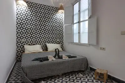 a bedroom with a bed with two ducks on it at Dar Bensuh 2ch privé in Marrakech
