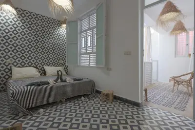 a room with a bed in the middle of a room at Dar Bensuh 2ch privé in Marrakech