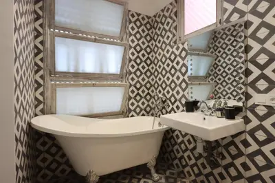 a bathroom with a tub and a sink and a window at Dar Bensuh 2ch privé in Marrakech
