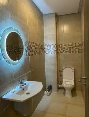 a bathroom with a sink and a toilet and a mirror at Apartment au cœur de Marrakesh in Marrakech