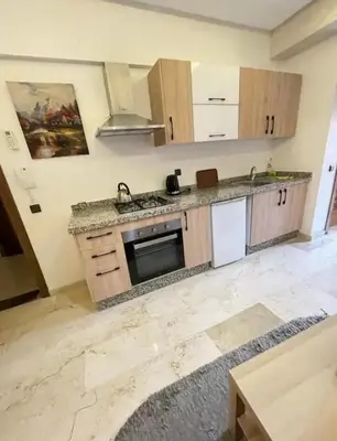 a kitchen with a sink and a stove top oven at Apartment au cœur de Marrakesh in Marrakech