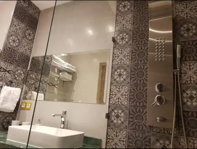 a bathroom with a sink and a mirror at Urban Chic 2 bedrooms in Utimate City Center in Marrakech