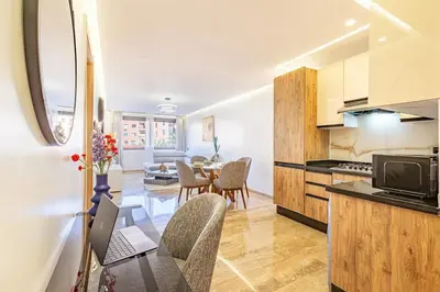a kitchen and living room with a table and chairs at New 1BR appt in gueliz in Marrakech