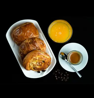 a tray of pastries and a cup of orange juice at Comfort bubble ideally located in Guéliz in Marrakech