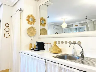 a white kitchen with a sink and a mirror at Comfort bubble ideally located in Guéliz in Marrakech