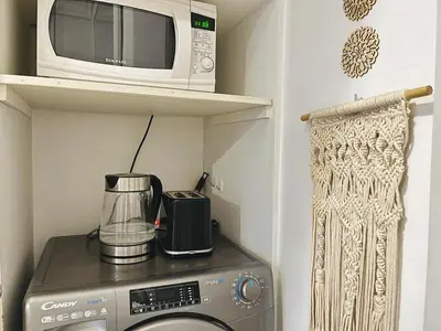 a microwave sitting on top of a stove at Comfort bubble ideally located in Guéliz in Marrakech
