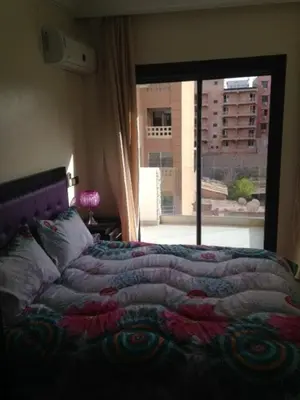 a bedroom with a bed with a view of a balcony at Appartement Meublé Au Centre de Gueliz in Marrakech