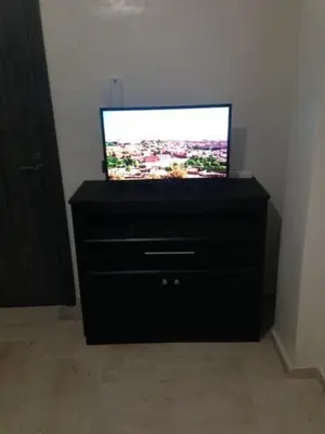 a television sitting on a dresser in a room at Appartement Meublé Au Centre de Gueliz in Marrakech