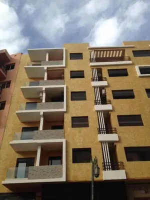 a tall building with balconies on the side of it at Appartement Meublé Au Centre de Gueliz in Marrakech