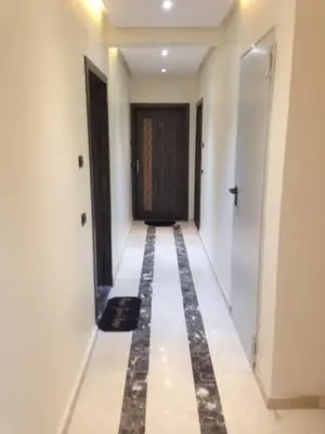 a hallway of a building with white walls and a door at Appartement Meublé Au Centre de Gueliz in Marrakech