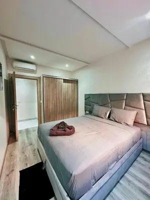 a bedroom with a large bed in a room at Appartement De Luxe Avec Piscine a Marrakech in Marrakech
