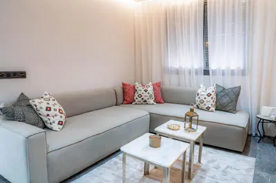 a living room with a couch and a table at Nuit d'Amazay in Marrakech