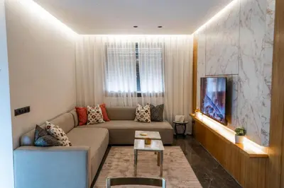 a living room with a couch and a tv at Nuit d'Amazay in Marrakech