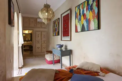 a bedroom with a bed and a table with a desk at Dar Lysis private with pool and breakfasts in Marrakech