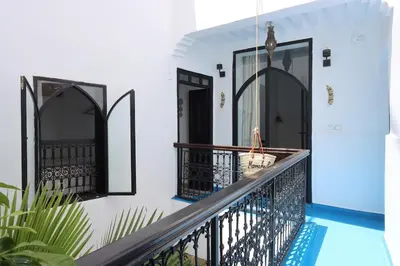 a balcony of a house with a swimming pool at riad la girafe blanche de marrakech in Marrakech