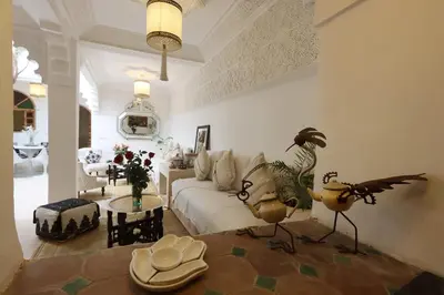 a living room with a white couch and a table at Riad L'Hana, 3 ch, exclu medina in Marrakech
