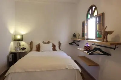 a bedroom with a large bed and a window at Riad L'Hana, 3 ch, exclu medina in Marrakech