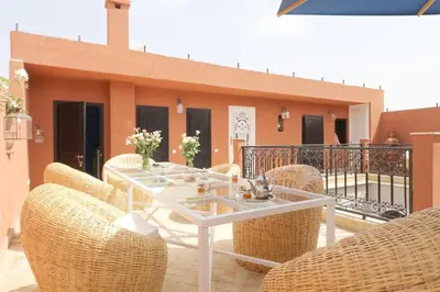 a white table and chairs on a balcony at Riad Lytes breakfast pool comfort private in Marrakech