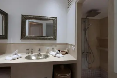 a bathroom with a sink and a shower at Riad Lytes breakfast pool comfort private in Marrakech