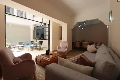 a living room with a couch and a table at Riad Lytes breakfast pool comfort private in Marrakech