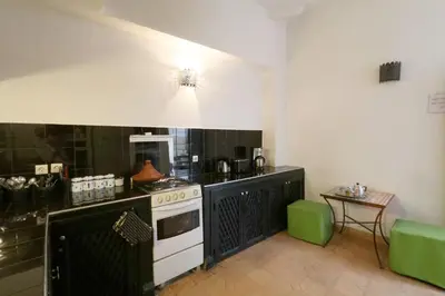 a kitchen with a stove and a counter top at Riad XCIX, basin, 3 bedrooms in Medina excluded in Marrakech