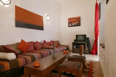 a living room with a couch and a table at Riad XCIX, basin, 3 bedrooms in Medina excluded in Marrakech