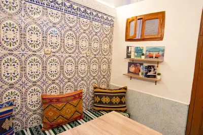 a room with two pillows and a patterned wall at Smile Hostel in Marrakech