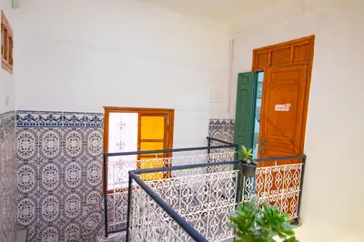a balcony with two doors and a stair railing at Smile Hostel in Marrakech