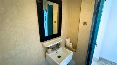 a bathroom with a sink and a mirror at Riad Abi in Marrakech